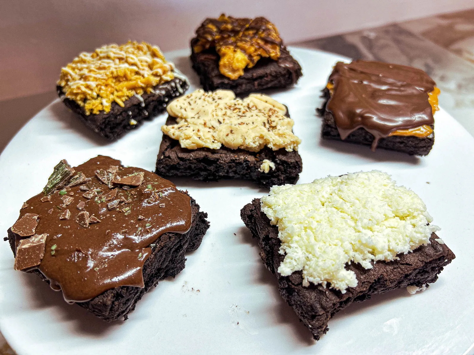 Four brownie flavours on a serving plate, ready for a celebration